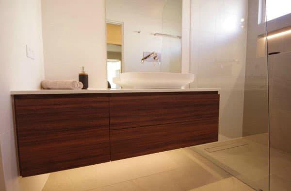 A photo of a warm feeling bathroom, with a sink.