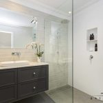 A photo of a bathroom, with a sink and shower.