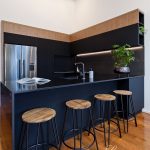 A photo of a kitchen with 4 chairs.