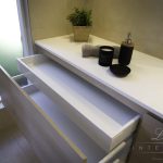 A photo of a bathroom counter top with drawers.