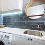 A photo of a laundry sink and washing machine.