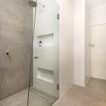 A photo of a shower and bathroom area.