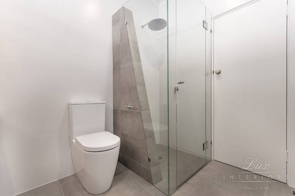 A photo of a bathroom area, with a toilet and shower.