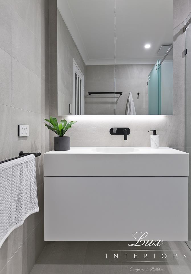 A photo of a floating vanity in a bathroom renovation done by Lux Interiors.