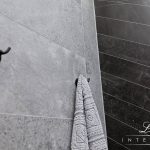 A photo of a shower with towel racks.