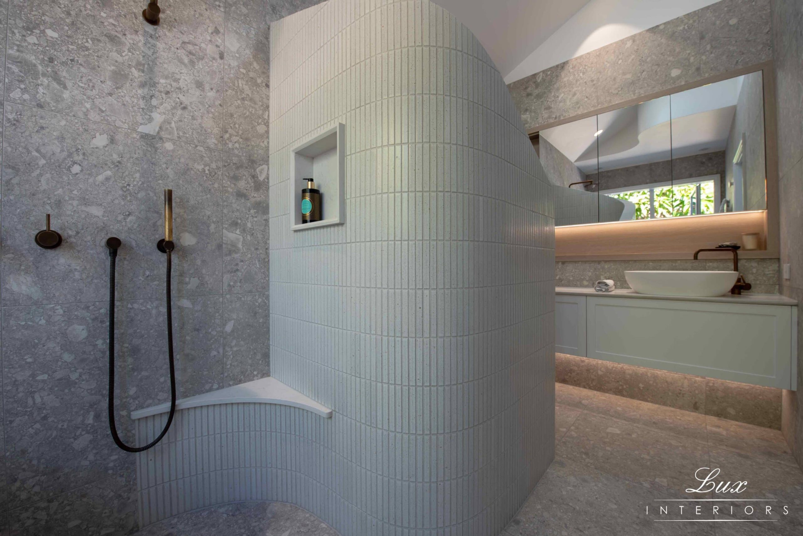 A photo of a bathroom area, with a shower and sinks in the background.