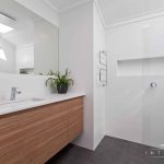 A photo of a bathroom area, with a shower in the background.