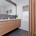 A photo of a bathroom area, with dual sinks.