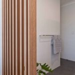 A photo of a bathroom area, with a towel rack in the background.