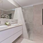 A photo of a bathroom area, with dual sinks and a shower.