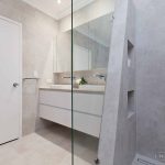 A photo of a bathroom area, with dual sinks and a shower.