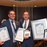 A photo of Kyle and Andrew at the KBDI Awards 2019. They are holding 5 awards.