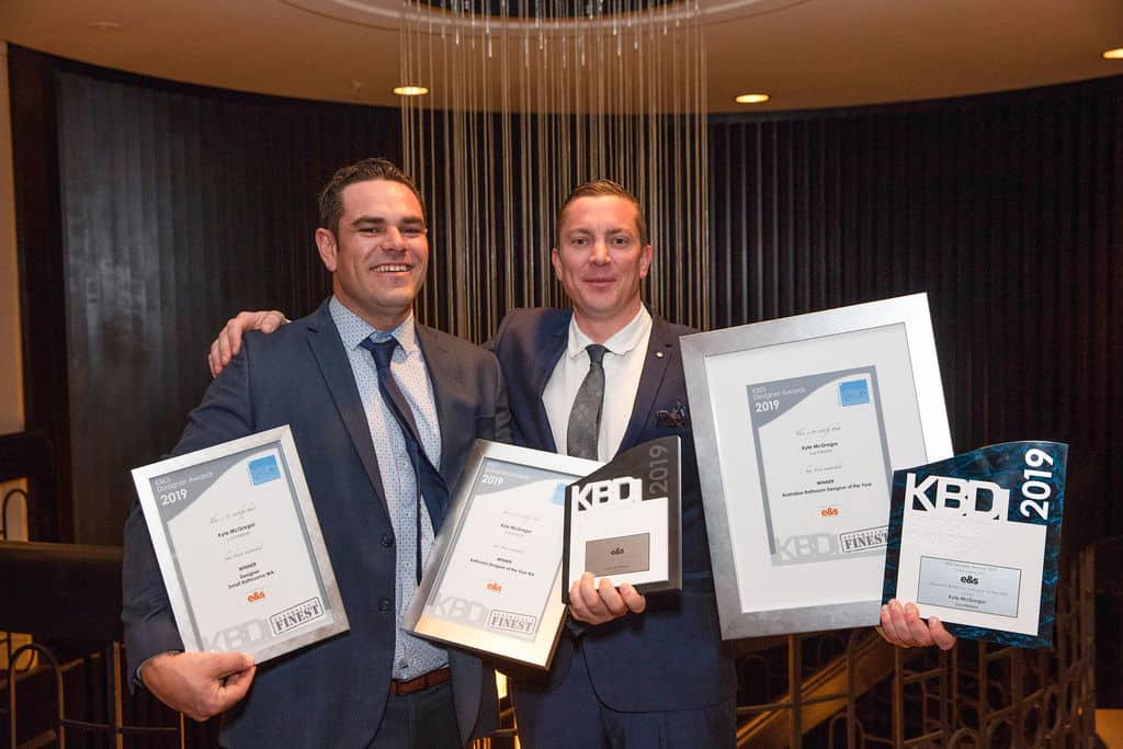 A photo of Kyle and Andrew at the KBDI Awards 2019. They are holding 5 awards.