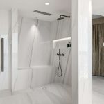 A photo of a shower area, with a ledge to sit down on whilst showering.