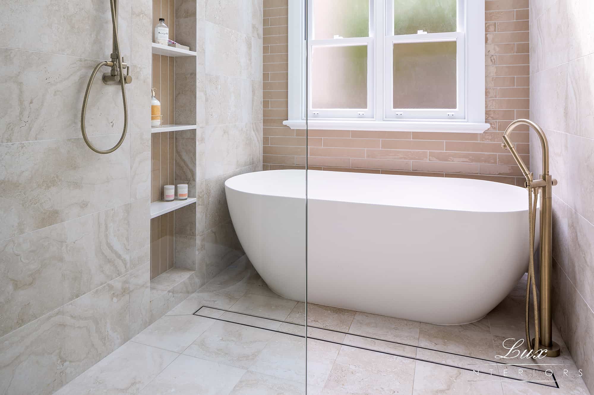 A photo of a bath tub next to a shower.