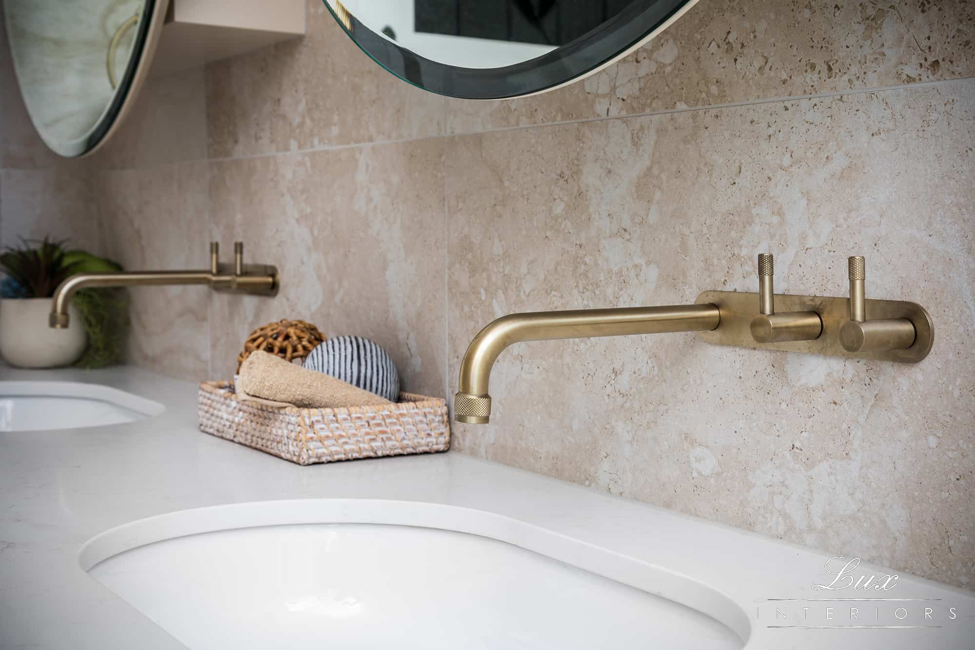 A photo of a sink area, with a gold tap.