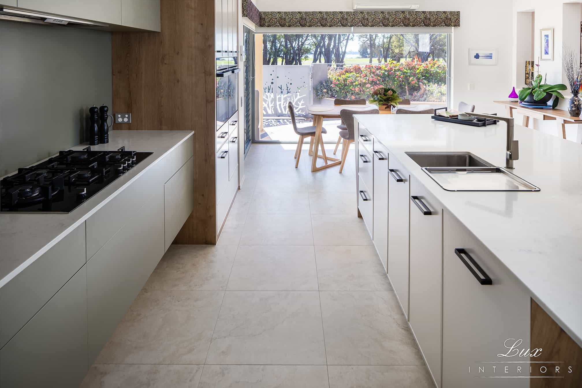 A photo of a kitchen area, with a stove and sink.