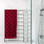 A photo of a towel rack, with a red towel on it.