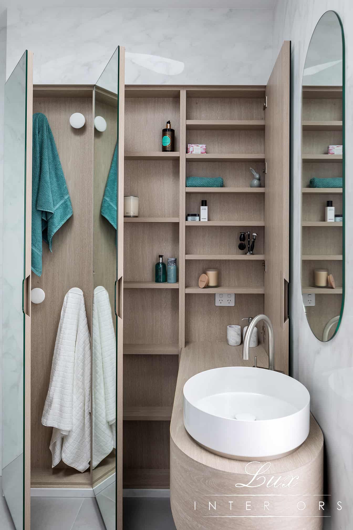 A photo of a storage area in a bathroom.