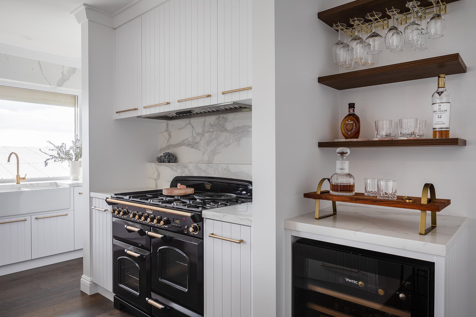 A photo of a black, traditional looking oven with an alcohol cabinet to the side and an oven on the other side.