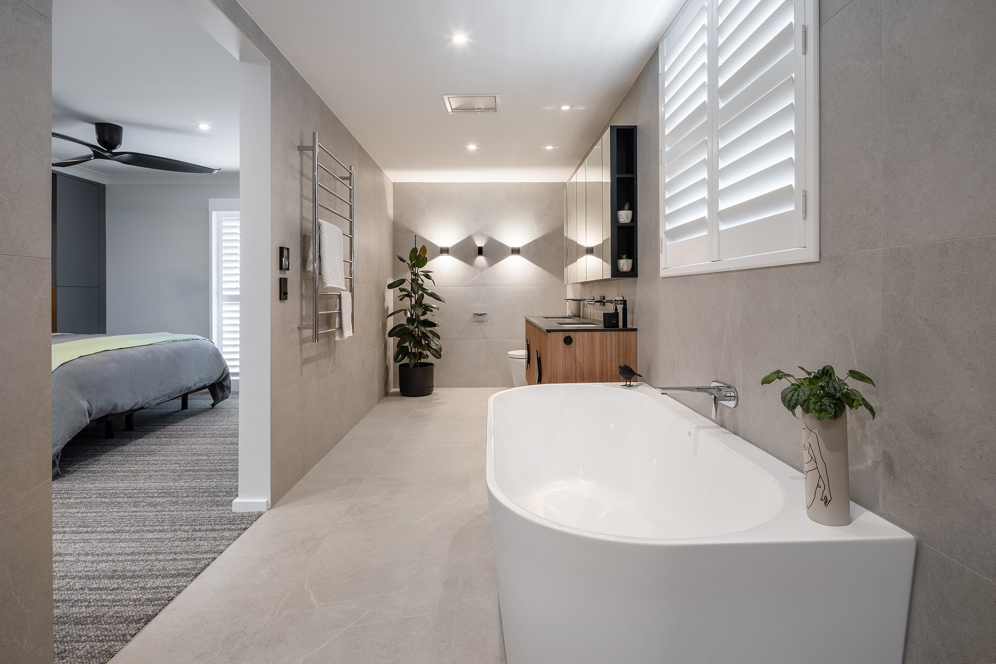 A photo of an ensuite bathroom, with a large tub, toilet and sink.