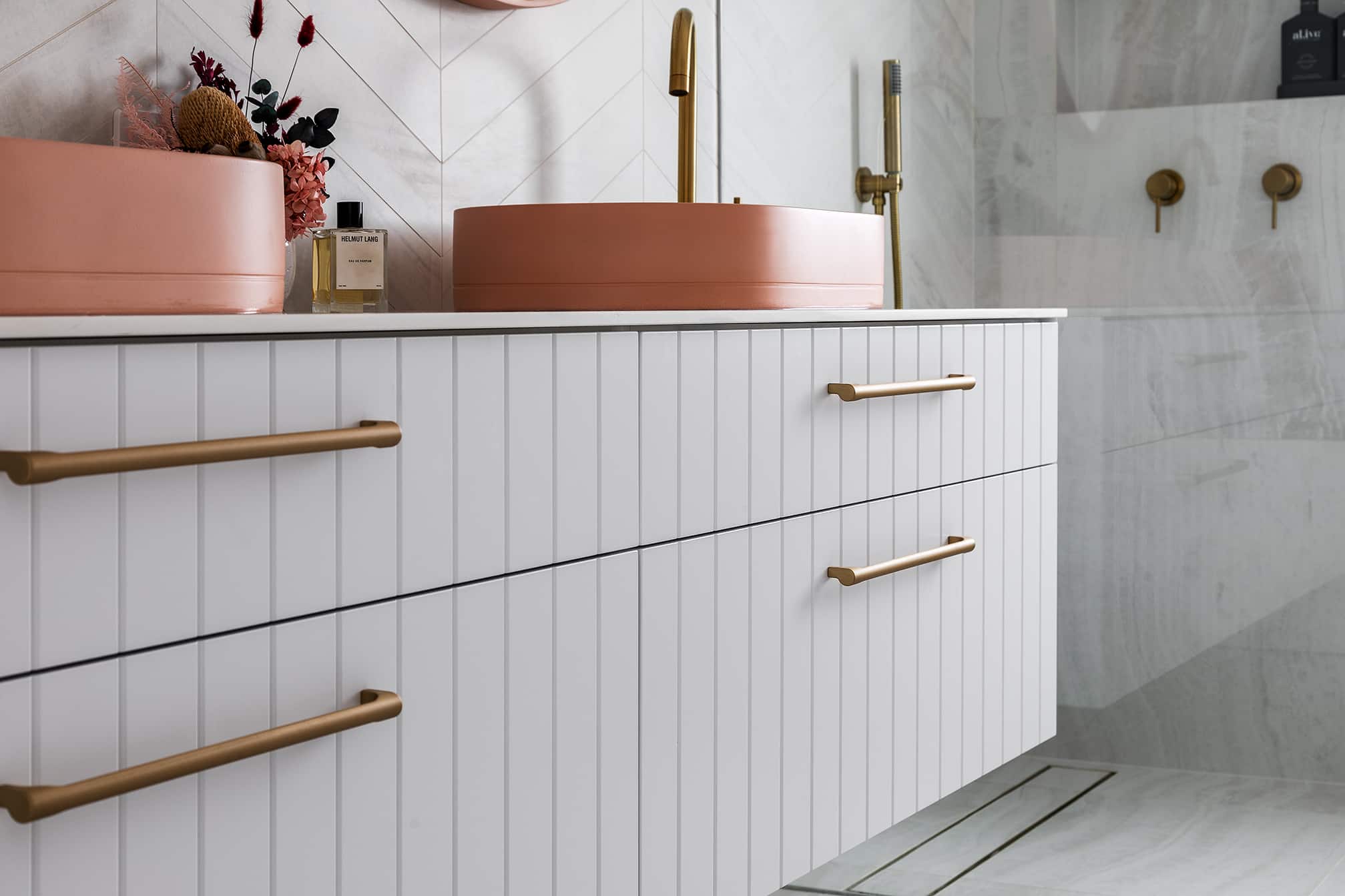 A photo of a bathroom sink, focusing on the cupboards.