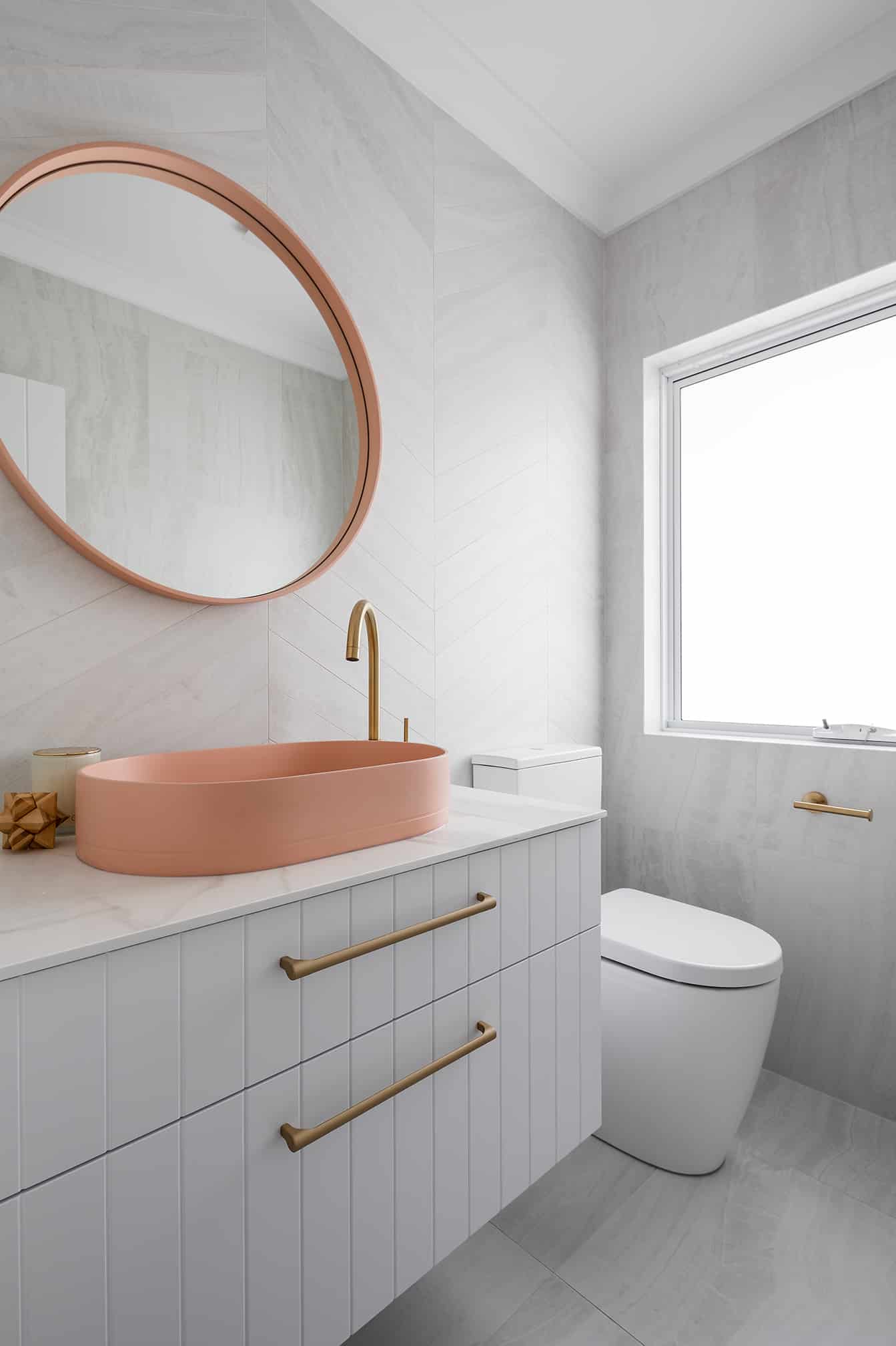 A photo of a sink and toilet behind it.