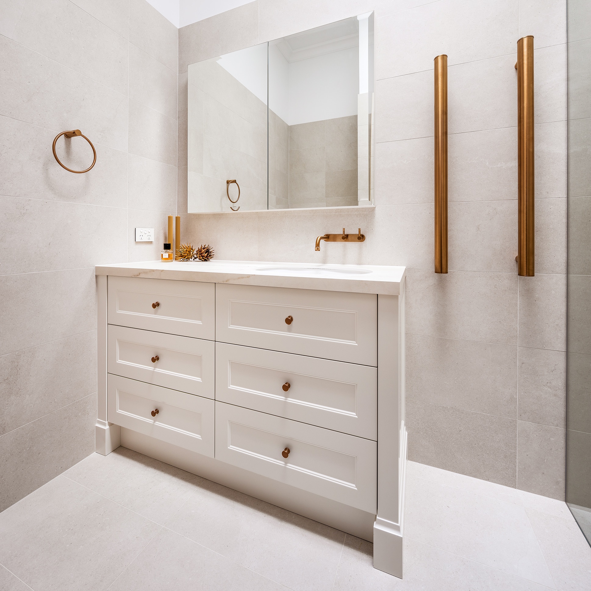 A photo of a sink, with 6 drawers and a towel rail next to it.