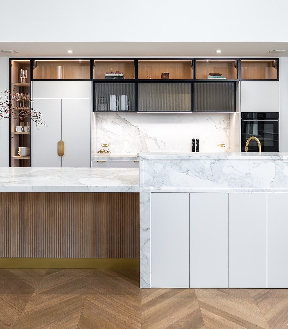 A photo of a kitchen area, with a cupboard and sink.