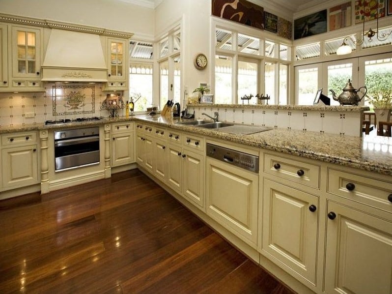 A photo of a kitchen area, with a stove and sink.