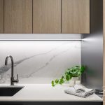 A photo of a laundry area, with a large sink and towels.