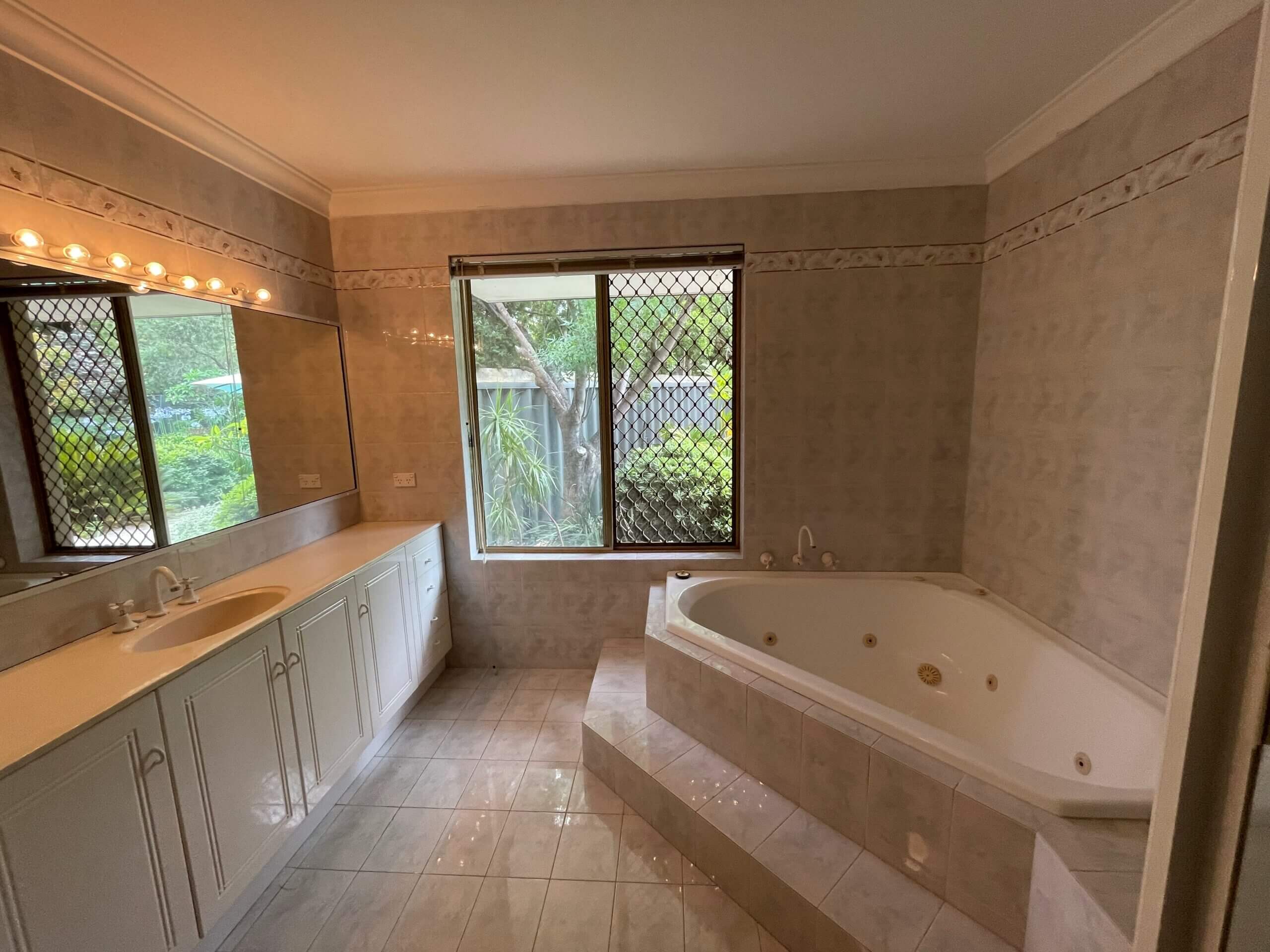 A photo of a bathroom area, with a large bath tub in the Lovegrove project.