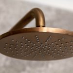 A photo of a gold shower head.