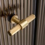 A photo of a gold door handle.