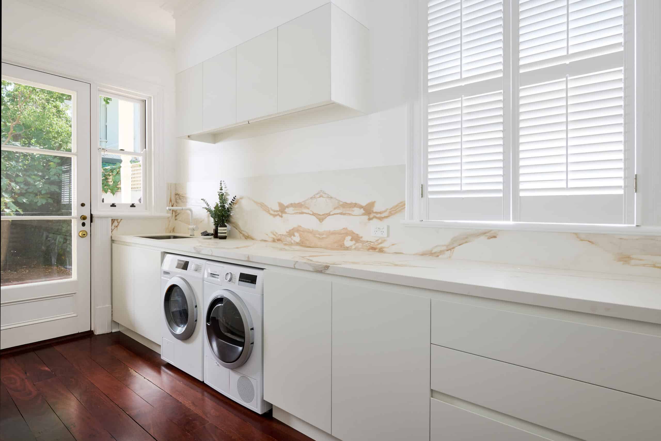 A photo of a newly renovated laundry area, with washing machine and dryer.