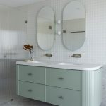 A photo of a bathroom sink, with a shower in the background.