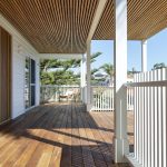 A photo of a house patio, surrounded by wooden boards and panels.