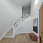 A photo of a white, curved staircase.