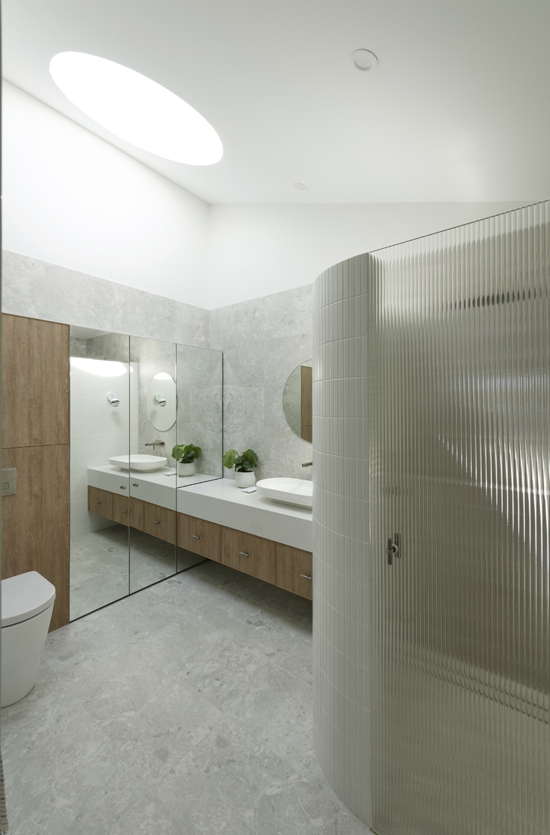 A photo of a bathroom, with a shower and toilet.