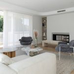 A photo of a living room area, with couches and chairs and a nice rug on the floor.