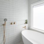 A photo of a bathroom shower and bathtub, all white.