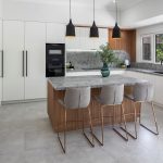 A photo of a kitchen, with a centre console and sink.