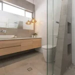 A photo of a bathroom with a sink, toilet and shower.