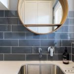 A photo of a kitchen area, with tiles on the wall.