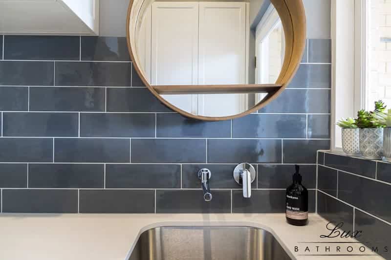 A photo of a kitchen area, with tiles on the wall.