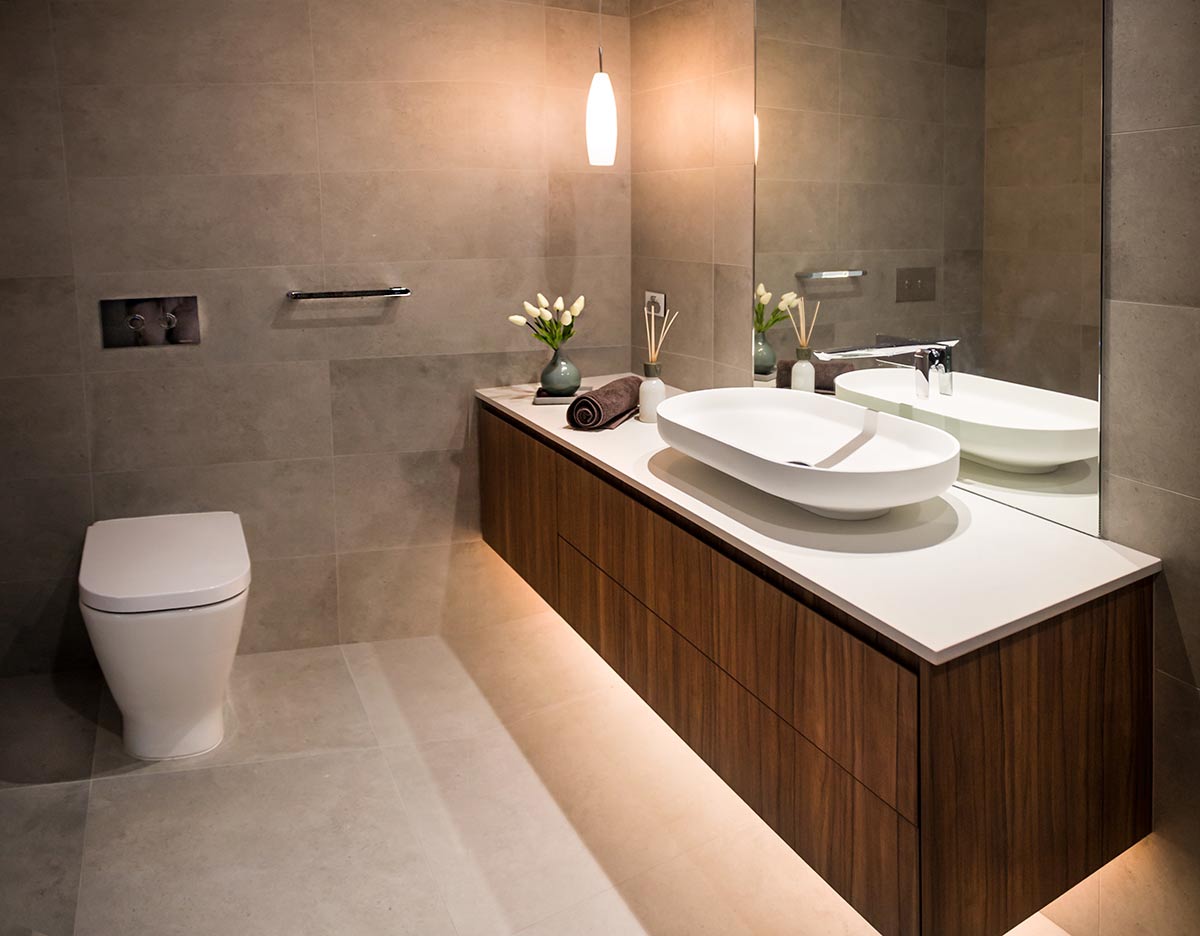 A photo of a bathroom, with a toilet and sink.