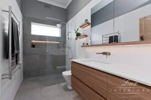 A photo of a bathroom with a shower, toilet and sink.