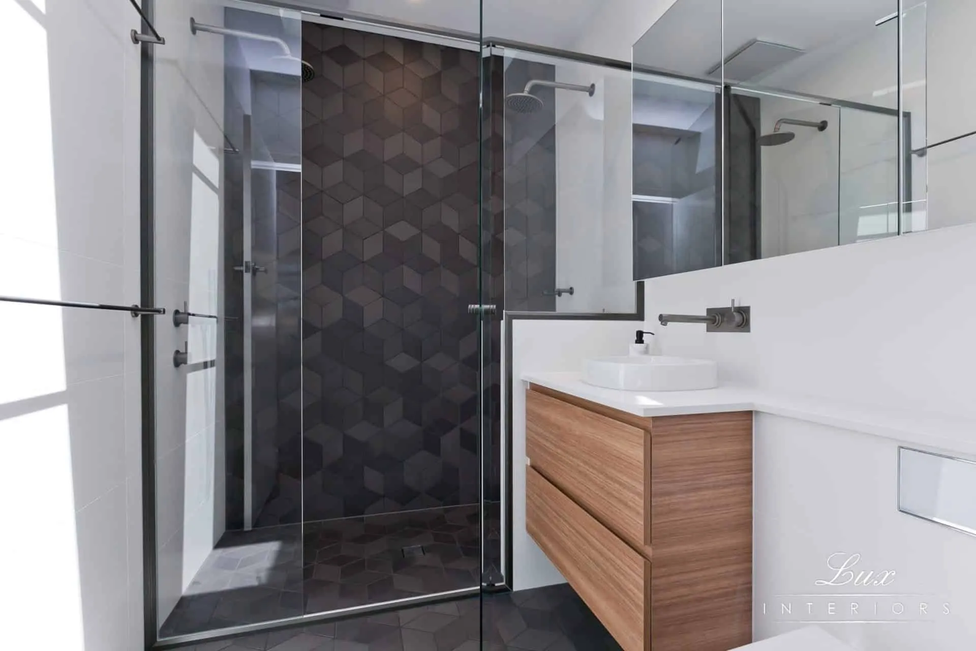 A photo of a bathroom with a sink, shower and toilet