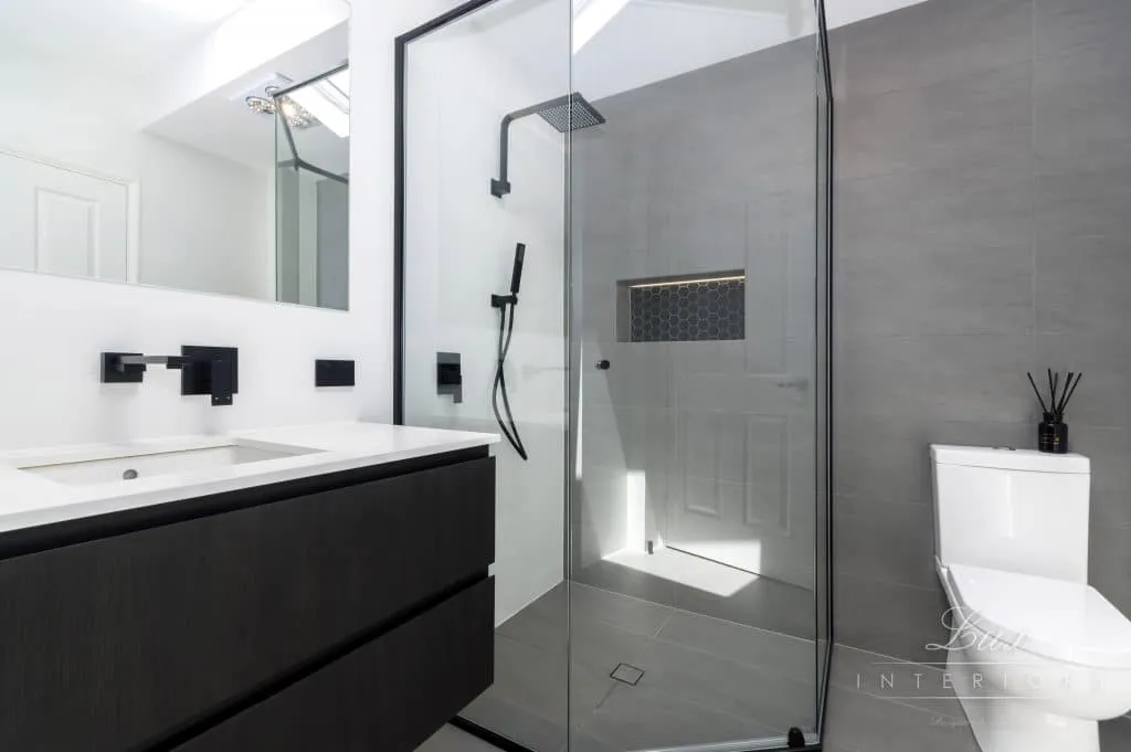 A photo of a bathroom with a sink, toilet and shower.