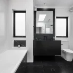 A photo of a bathroom with a bathtub, sink and toilet.